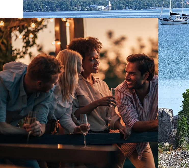 Group of friends on a deck, drinking wine and laughing